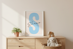 Shane baby name print framed on nursery table with soft decor